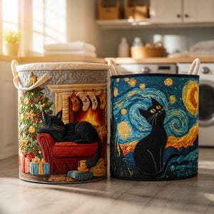 May include: Two cylindrical fabric storage baskets with rope handles. The left basket features a quilted scene of a black cat sleeping on a red chair by a Christmas tree and fireplace. The right basket displays a black cat against a swirling blue starry night sky.