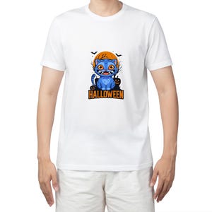 May include: White t-shirt with a blue cartoon cat design. The cat has orange eyes, fangs, and a pumpkin. The design includes an orange moon and bats, with the word "HALLOWEEN" printed below in orange.