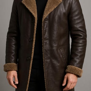 May include: A dark brown leather coat with a shearling collar and cuffs. The coat has a button-up front and a classic, tailored design. The coat is a warm outerwear garment.