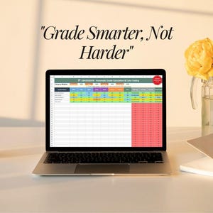 May include: A laptop showing a spreadsheet with colour-coded data is on a white desk. The text "Grade Smarter, Not Harder" is above the laptop. A glass vase with yellow flowers and a small gold notebook are also on the desk.