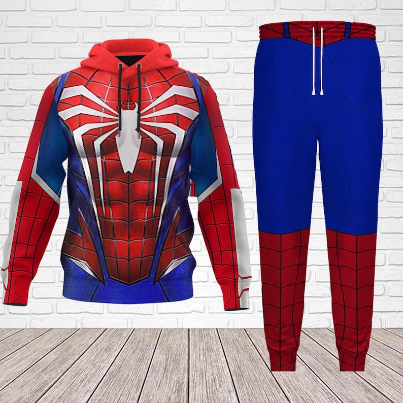 May include: A red, blue, and white Spider-Man themed hoodie and matching pants set. The hoodie features a large spider emblem on the chest and back. The pants are blue with red accents.
