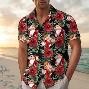 May include: A short-sleeved button-down shirt featuring a black background with a repeating pattern of red hibiscus flowers, green tropical leaves, and the cartoon character Grumpy from Snow White. The shirt has a classic collar and a button front.