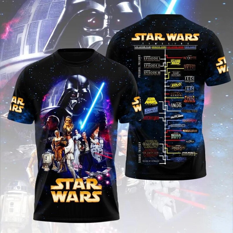 May include: Black Star Wars t-shirt featuring Darth Vader with a blue lightsaber and other characters. The front of the shirt has the Star Wars logo. The back of the shirt displays a Star Wars timeline.
