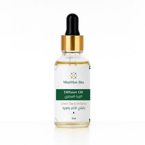 May include: A clear glass bottle of MusMus Bio Diffuser Oil with a black dropper and gold cap. The label is white and green, with text in English and Arabic. The bottle contains 30 ml of Green Tea & Verbena oil.