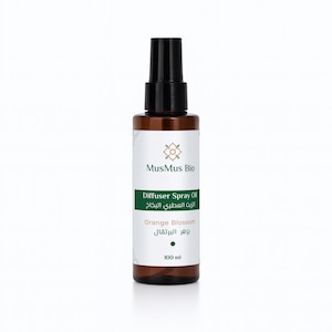 May include: A brown glass bottle with a black spray nozzle. The label reads "MusMus Bio" and "Diffuser Spray Oil - Orange Blossom". The bottle contains 100 ml of product.