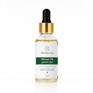 May include: A clear glass bottle of MusMus Bio Diffuser Oil with a black dropper and gold cap. The label is white and green, with text in English and Arabic. The bottle contains 30 ml of Green Tea & Verbena oil.
