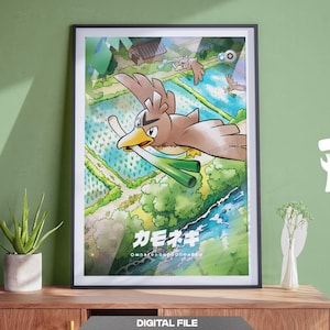 May include: A framed vertical art print featuring a brown bird character holding a green leek in its beak, flying over a landscape of blue water fields and green trees. The Japanese text "カモネギ" is printed in white at the bottom of the illustration.