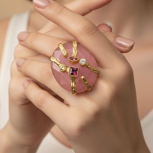 May include: A white ceramic mug with a black handle and the text "But First, Coffee" in a bold, black font. The mug is set against a blurred background, suggesting a cozy setting. The mug appears to be approximately 4 inches tall.