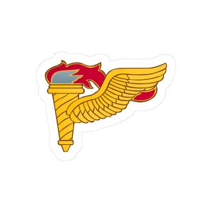May include: A sticker featuring a gold torch with red flames and a gold wing. The torch has a detailed, textured design, and the wing is spread out. The sticker has a white border.