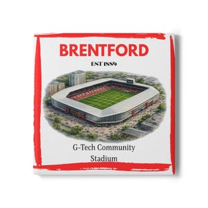 May include: Square white canvas art featuring a detailed illustration of the G-Tech Community Stadium. The word "BRENTFORD" is at the top, with "EST 1889" below it. Red accents frame the artwork.