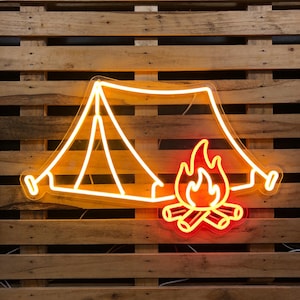 May include: Neon sign featuring a camping tent and a campfire. The tent is outlined in a warm yellow, with the campfire in a bright red-orange. The sign is mounted on a wooden pallet background.