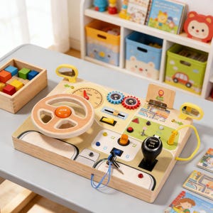 May include: Wooden toy car dashboard with a steering wheel, gear shift, and various interactive elements. Features a speedometer, colorful gears, and a key. Includes a wooden box with colorful blocks. A fun educational toy.