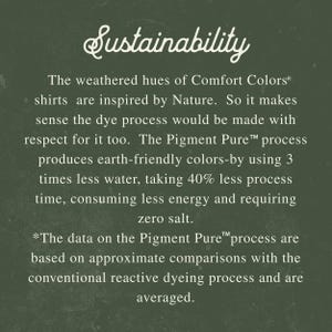 May include: Text on a dark green background reads "Sustainability." The text describes the earth-friendly dye process used for Comfort Colors shirts, including less water, time, energy, and zero salt.