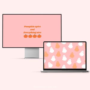May include: A computer monitor and laptop display fall-themed wallpapers. The monitor displays the text "Pumpkin spice and Everything nice" with pumpkin illustrations. The laptop shows a pattern of white and orange ghosts on a pink background.