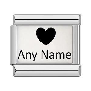 May include: A rectangular silver-toned modular charm link featuring a polished metallic finish. The centre of the link displays a solid black heart icon positioned above the black text Any Name, creating a clear and high-contrast design.