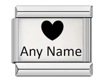 May include: A rectangular silver-toned modular charm link featuring a polished metallic finish. The centre of the link displays a solid black heart icon positioned above the black text Any Name, creating a clear and high-contrast design.