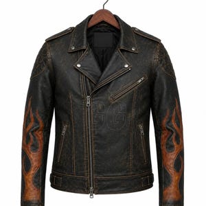 Puede incluir: Chaqueta de cuero negro desgastado de estilo motero clásico. Cuenta con cuello con solapas, cierre de cremallera asimétrico y diseño de llamas en las mangas. La chaqueta está colgada en una percha de madera.
