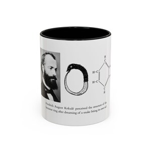 May include: A white ceramic mug with a black interior featuring a black and white portrait of Friedrich August Kekulé, an illustration of an Ouroboros snake, and a benzene chemical structure diagram with text describing the discovery of the ring.