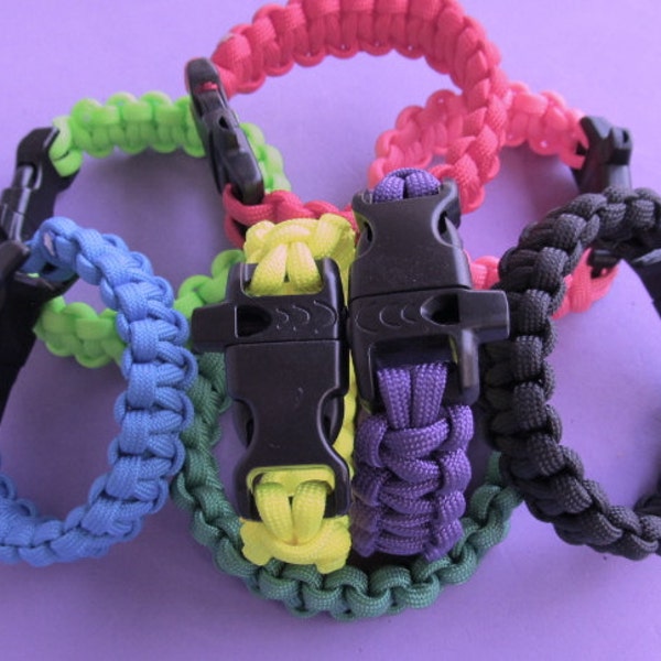 Paracord survival bracelets, solid colors.Buckle has built in whistle. Measure wrist for size, order color number from chart.NEW COLORS!