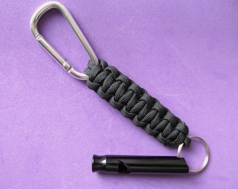 Whistle Keychain. Black paracord keychain with 2.25" aluminum safety whistle, carabiner clip. Loud whistle key ring for fun and safety.
