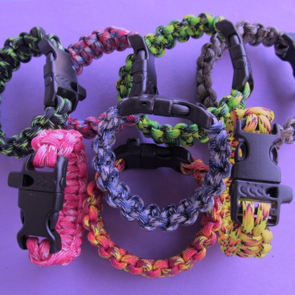 Paracord survival bracelets in mixed colors. Now NEW COLORS!   Whistle in Buckle.  Measure wrist for size. Order color number from chart.