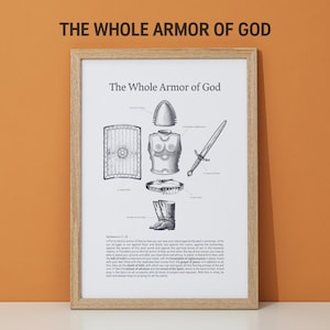 May include: A framed print with the text "The Whole Armor of God" and illustrations of armor pieces, including a shield, helmet, breastplate, belt, boots, and sword. The print is in black and white, with a light brown wooden frame.
