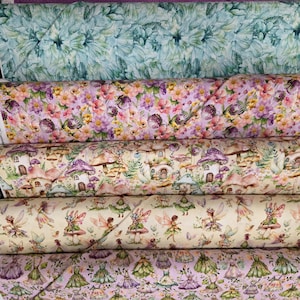 May include: Six stacked bolts of fabric featuring various patterns including purple geometric shapes, teal floral prints, colorful wildflowers, mushroom houses, winged fairies, and dresses in shades of purple, green, and cream on a light background.
