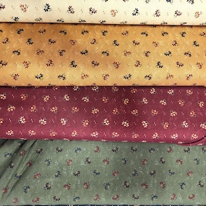 May include: Five fabric swatches in cream, gold, burgundy, olive green, and navy blue. Each fabric features a repeating floral pattern in colours like red, blue, and yellow. The fabrics are stacked horizontally, displaying the different colour options available.