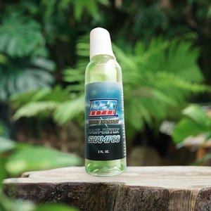 May include: A clear bottle of Jet Detox Hair-Detox Shampoo with a white cap. The label is blue and white with the text "Jet Detox" and "Works Instantly". The bottle contains 2 fl oz of shampoo.