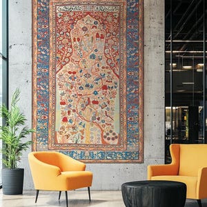 May include: A large, ornate tapestry with a central tree design, framed by a blue border, hangs on a concrete wall. Two orange armchairs and a black ottoman sit below. A potted plant is on the left.