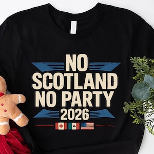 May include: Black t-shirt with the text "NO SCOTLAND NO PARTY 2026" in white and blue. The shirt features flags of Canada, Mexico, and the United States. A gingerbread man and red fabric are next to the shirt.