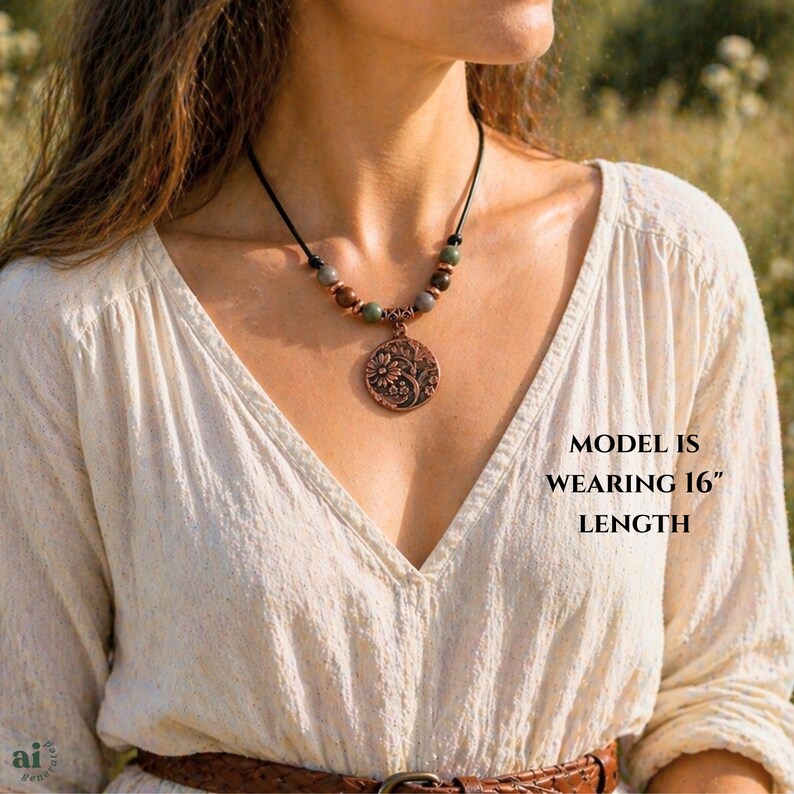A necklace featuring a black cord strung with multi-colored stone beads, copper-toned spacers, and a central circular copper pendant embossed with a detailed floral design. The pendant displays a raised pattern of flowers and leaves.