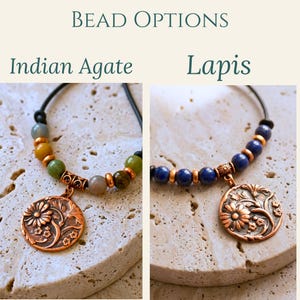 May include: Two bracelets featuring copper-toned floral pendants and round beads. The left bracelet displays multi-colored Indian Agate beads, while the right bracelet features deep blue Lapis beads. Both are strung on black cords with copper spacers.