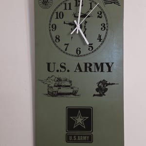 May include: Rectangular wall clock with a green background featuring a clock face, the text "U.S. ARMY", and military-themed graphics. The clock also includes the text "Be All You Can Be."