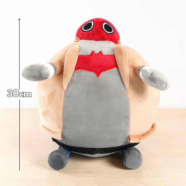 May include: A plush toy in the shape of a character, approximately 12 inches tall. It features a red head with white-rimmed eyes, a tan coat, a gray torso, and gray arms. The toy has blue feet and a black band around the base.