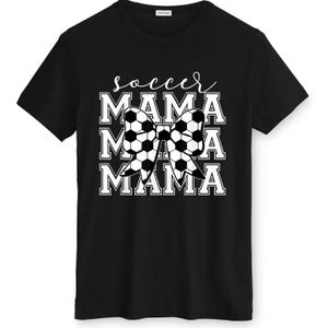 May include: Black t-shirt with the text "soccer MAMA" in white. The word "soccer" is in cursive, and "MAMA" is stacked three times with a soccer ball bow in the center. The shirt is made of a soft material.