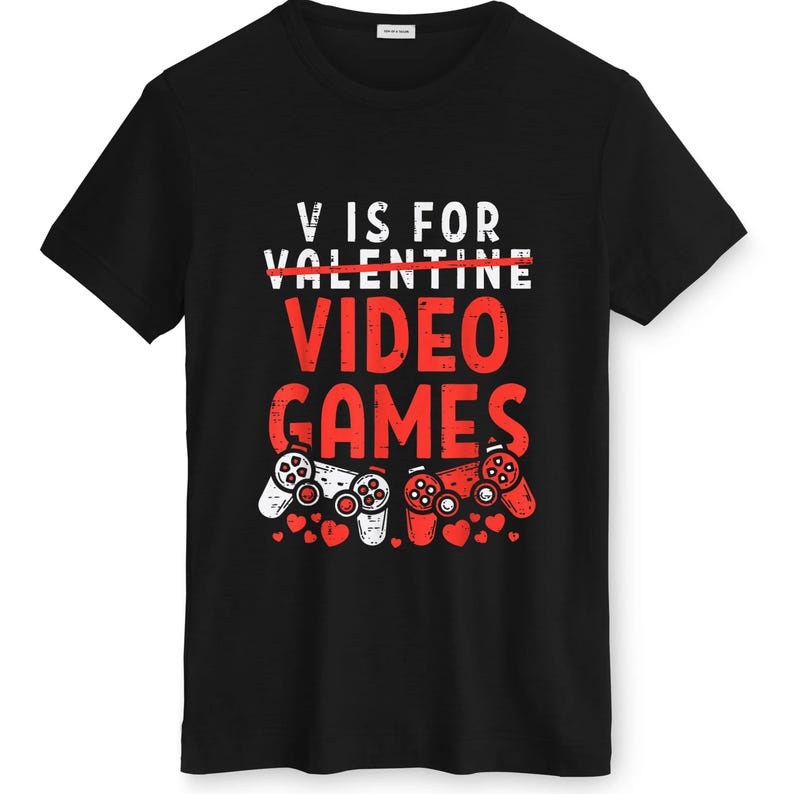 May include: Black t-shirt with a graphic design. The design features the text "V IS FOR VIDEO GAMES" in white and red, with two game controllers and small red hearts.