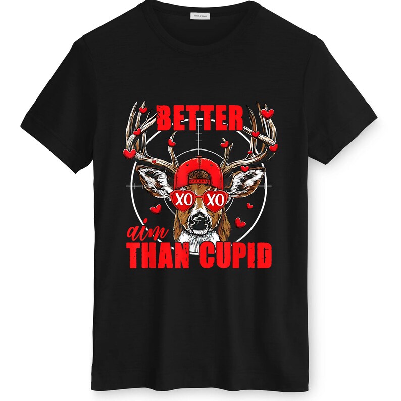 May include: Black t-shirt featuring a deer wearing a red cap and sunglasses, with the text "BETTER aim THAN CUPID" in red. The deer's antlers are adorned with red heart shapes, and the design is set against a white target.