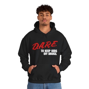 May include: Black hooded sweatshirt with the text "D.A.R.E. TO KEEP KIDS OFF DRUGS" in red and white. The sweatshirt has a front pocket and a drawstring hood.