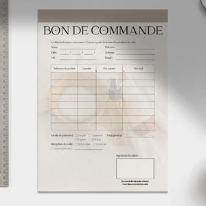 May include: A notepad with the words "BON DE COMMANDE" at the top. The notepad has lines for filling in details such as name, date, and product information. A metal ruler is on the left.