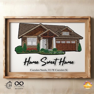 May include: Embroidered artwork of a house with a brown roof, white trim, and a garage. The text "Home Sweet Home" and "Camden Yards, 333 W Camden St" are below the house. The artwork is framed in a light brown wooden frame.