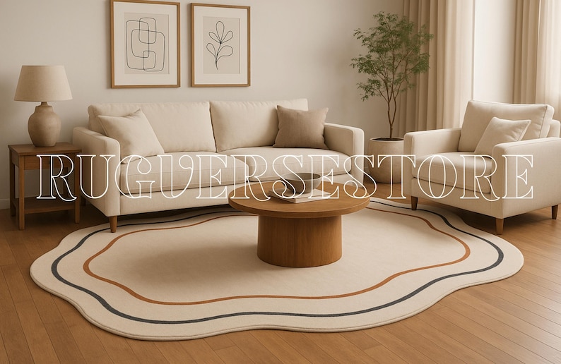 May include: A living room with a cream sofa, armchair, and a round wooden coffee table. A beige rug with wavy edges and brown and navy stripes is on the wooden floor. The text "RUGVERSESTORE" is overlaid on the image.