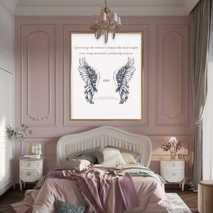May include: A framed wall art print featuring a pair of detailed black and white angel wings. The artwork includes the text "I grew wings the moment I dropped the dead weight. I am rising, protected, and finally at peace" and the number "444". The print hangs above a bed.