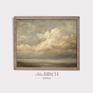 May include: A framed landscape print featuring a cloudy sky with shades of beige, gray, and brown. The artwork has a vintage aesthetic, with a soft, diffused light. The frame is a light brown color. The text "BlueBIRCH printco" is at the bottom.