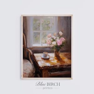 May include: A framed print of a still life painting. A small table holds a vase of pink roses, a cup and saucer, and sits near a window. The painting has a warm color palette with soft lighting. The text "Blue Birch printco" is at the bottom.