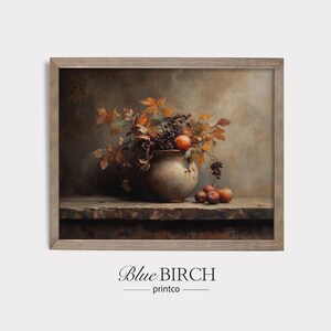 May include: A framed still life painting featuring a rustic vase filled with autumn leaves, grapes, and small red apples. The artwork has a warm color palette with brown, orange, and red tones. The text "Blue Birch printco" is at the bottom.