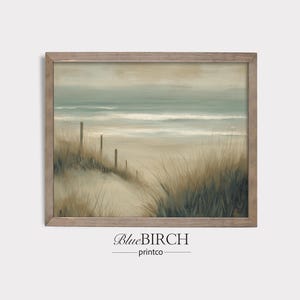 May include: A framed landscape print depicting a beach scene. The artwork features a sandy path leading to the ocean, with tall grasses and wooden posts. The color palette includes muted greens, blues, and beige tones, creating a serene coastal aesthetic. The text "BlueBIRCH printco" is at the bottom.