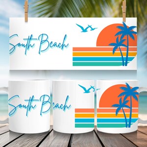 May include: White ceramic mug with the words "South Beach" in blue script. The mug features a sunset design with palm trees, a rising sun, and flying birds. The design is repeated on a sign above the mug.