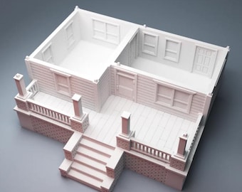 May include: A miniature white model of a house with a porch, steps, and a brick facade. The house has multiple windows and doors, and the interior is visible. The model is designed with detailed architectural features.