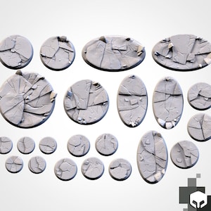May include: A selection of grey, textured, cracked stone bases in various shapes and sizes. The bases include round, oval, and irregular shapes, with detailed surface textures. Suitable for miniature gaming or model building.